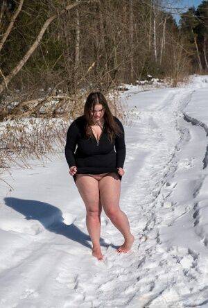Brunette BBW rids ball gag and ropes while posing nude and barefoot in snow on pornstar6.com