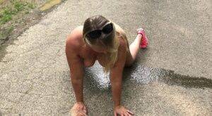 Blonde amateur Sweet Susi takes a piss while naked on a paved road on pornstar6.com