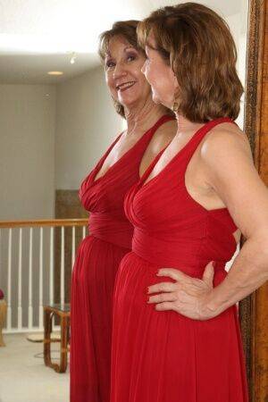 30 plus redhead Lynn doffs a long red dress before pussy play afore a mirror on pornstar6.com