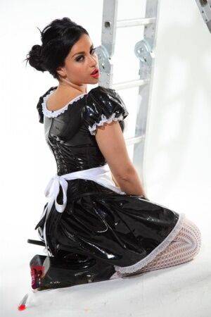 Dark-haired beauty Jasmine Jones models a latex maid uniform in sexy stockings on pornstar6.com