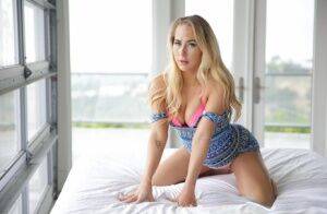 Blonde solo model Carter Cruise removes her dress and pink pretties on her bed on pornstar6.com