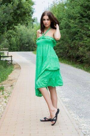 Sweet teen Evita Lima sets her great body free of a long dress on a sidewalk on pornstar6.com