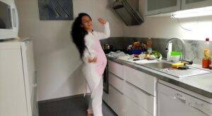 Horny and pregnant Lexi Dona undressing in the kitchen to sate her appetite on pornstar6.com