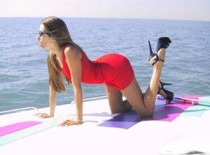 Solo girl Lori Anderson removes a red dress while getting naked atop a boat on pornstar6.com