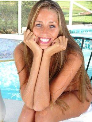 Amateur mom Lori Anderson making nude modeling debut beside swimming pool on pornstar6.com