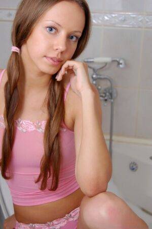 Barely legal sweetheart Natasha S sports long pigtails while taking a bath on pornstar6.com