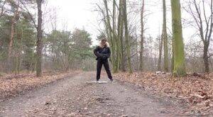 Solo girl Natasha Ink squats for a pee on a dirt road in glasses and a coat on pornstar6.com