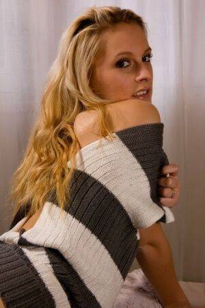 Blonde chick Joe shows her bald pussy in a sweater and black boots on pornstar6.com