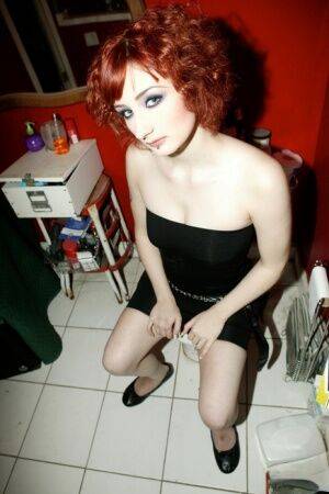 Pale redhead Violet Monroe gets naked in flat shoes while in a bathroom on pornstar6.com