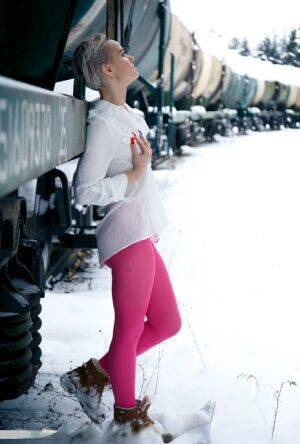 Short haired female displays her snatch by a train in crotchless hose on pornstar6.com