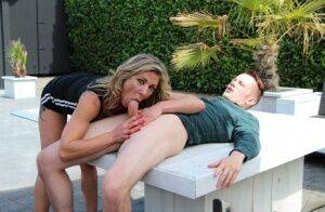 Blonde chick Nikky Clarisse does a DP on a patio sofa in red sneakers on pornstar6.com