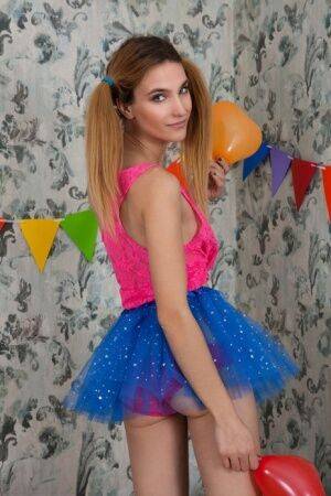 Tiny cutie Rosi shows her flat chest and tight slit in a tutu amid balloons on pornstar6.com