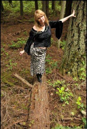 Mature lady Tasty Trixie hikes up her skirt for a quick piss in the woods on pornstar6.com