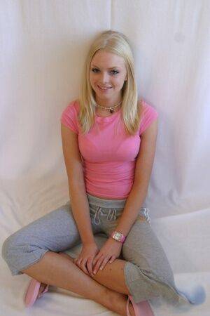 Cute teen girl Skye Model hangs out in a pink shirt and her yoga pants on pornstar6.com