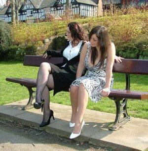 Clothed females admire each other high heeled shoes on a park bench on pornstar6.com