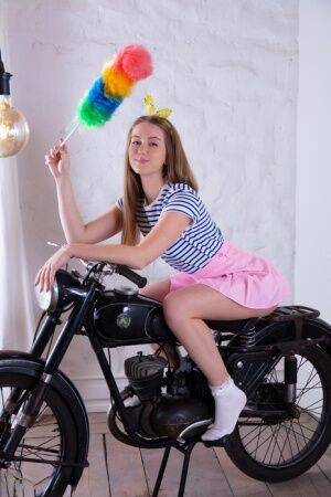 Adorable teen Milka gets totally naked in front of a vintage motorcycle on pornstar6.com