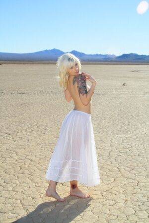 Sexy blonde Lynn Pops goes topless on a dry lake before exposing her vagina on pornstar6.com