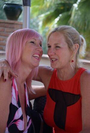 Middle-aged lesbians Melody & Molly MILF play with each others tits on a patio on pornstar6.com