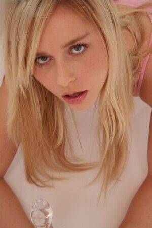 Hot blonde Kara Duhe on her knees shoving a glass dildo in her pretty face on pornstar6.com