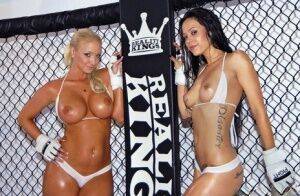 Busty lesbian babes stripping and posing in the wrestling cage on pornstar6.com