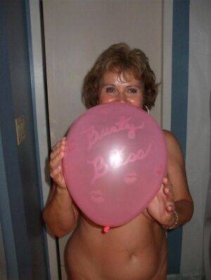 Mature lady models totally naked while playing with balloons on pornstar6.com