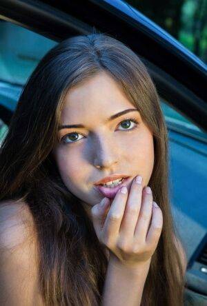 Beautiful teen girl models in the nude on passenger seat of car with door open on pornstar6.com