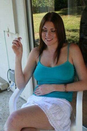 Barefoot chick Victoria Vonn smokes on the patio in a skirt and tank top on pornstar6.com