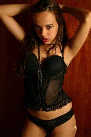Latina teen Miranda Mirelli models black lingerie and mesh stockings on pornstar6.com