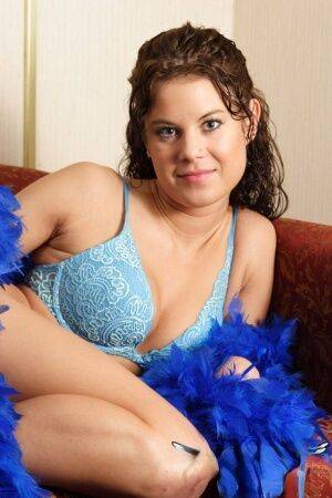 Brunette first timer Erin models non nude in elegant bra and blue feather boa on pornstar6.com