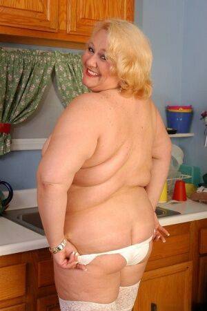 Older fat lady Britany models white stockings and underwear in the kitchen on pornstar6.com