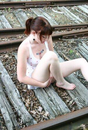 Redheaded girl Barbie A models a summer dress in bare feet on railway tracks on pornstar6.com