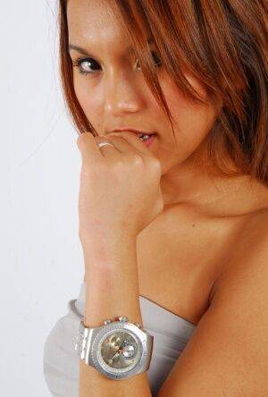 Sexy redhead Mocca models a Swatch Irony The Chrono watch in a clingy dress on pornstar6.com