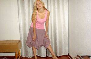 Clothed teen models in a skirt and tank top with curls put in her blonde hair on pornstar6.com