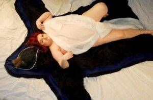 Fat redhead Black Widow AK models totally naked on a bearskin rug on pornstar6.com