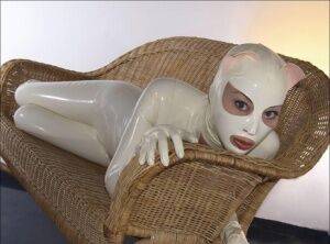 Bald female models rubber attire during a solo engagement on pornstar6.com