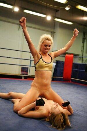 Pretty lesbians gasping and stripping each other in the wrestling ring on pornstar6.com