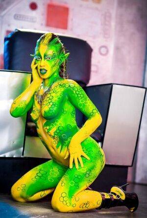 Kinky cosplay chick Tiffany Doll posing in body paint uniform and spreading on pornstar6.com