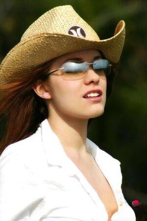 Farm girl in shades and a straw hat unbuttons her shorts and opens her shirt on pornstar6.com