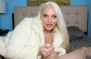 Platinum blonde chick Macy Cartel tugs on a dick while draped in a fur coat on pornstar6.com