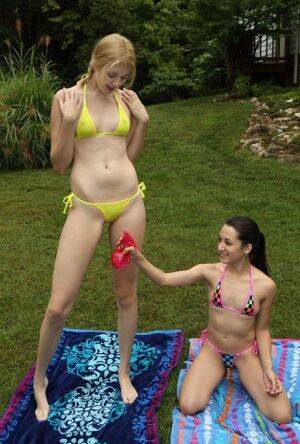 Short and tall lesbians remove bikinis before scissoring and fisting in yard on pornstar6.com