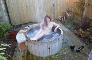 Amateur lady Barby Slut gets totally nude before getting in an outdoor hot tub on pornstar6.com