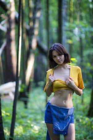 Skinny brunette Lara Masier gets completely naked in a mature forest on pornstar6.com