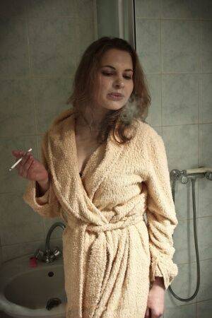 Solo model Vlada H smokes while fingering her pussy on bathroom floor on pornstar6.com