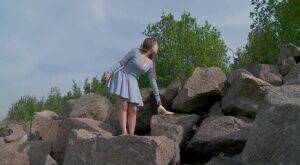 Barefoot girl Nastya squats for a piss on top of a bunch of boulders on pornstar6.com