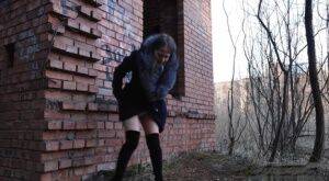 Distressed girl Nastya pulls down her tights to pee by an abandoned building on pornstar6.com