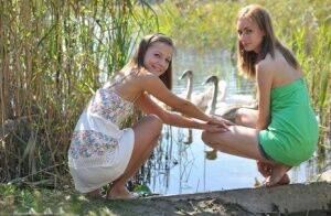 Young lesbians Nastya & Ashly get naked on a dock in the reeds on pornstar6.com