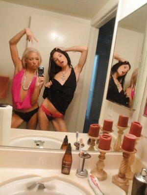 Skinny girls Kacey and Zoey showing off teenie tits while taking mirror selfie on pornstar6.com