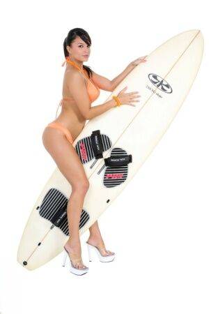 Sexy surfer girl Sarah peels off her bikini to model naked on her board on pornstar6.com