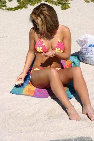 Teen solo girl Karen relaxes at the beach in a bikini and sunglasses on pornstar6.com