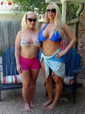 Blonde chicks Karen Fisher and Dee Siren loose their big tits from bikini tops on pornstar6.com